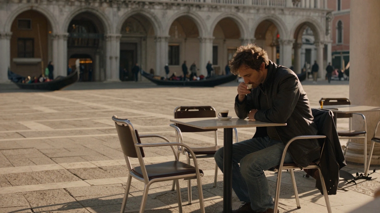 A man sits alone at a Venice café, an empty chair across from him, golden light casting long shadows as gondolas drift past in the blurred background.