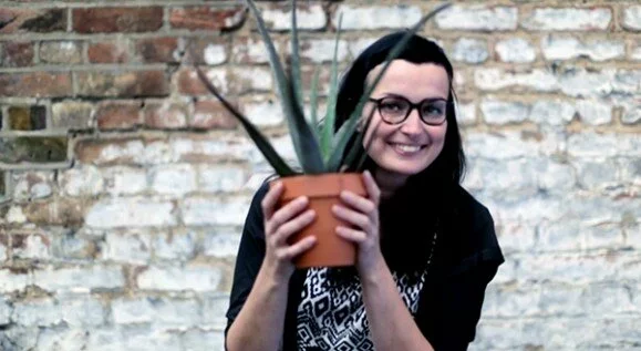 Young Woman with a plant - video screenshot